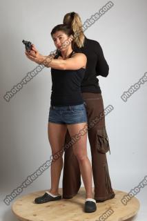 OXANA AND XENIA STANDING POSE WITH GUNS 4